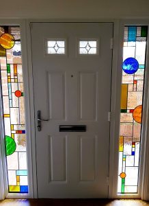 Two sidelights showing Frank Lloyd Wright inspired design of bright, colourful shapes for house in Staines-upon-Thames.