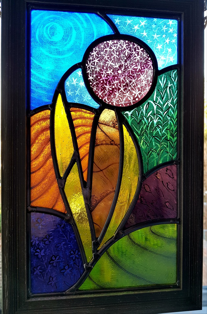 A contemporary stained glass design depicting a stylised Allium flower.
