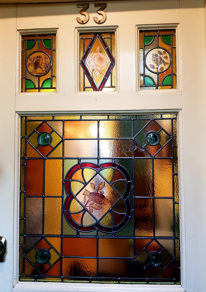 Stained glass door panels with painted birds restored for house in Hertford.